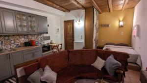 a living room with a couch and a kitchen with a bed at Diminio 3 Apartment at Livadi Arachova in Arachova