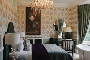 a bedroom with a bed and a chandelier at 40 Winks Hospitality in Durham