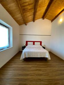 a bedroom with a bed and a wooden ceiling at Levante Flat - 100 m from the beach in Fano