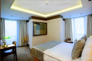 a hotel room with a bed and a television at AHC Ayasofya Hotel in Istanbul