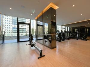 a gym with a table in a building with windows at 1 BRM 1 BATH, Southern Cross Station, Flagstaff in Melbourne