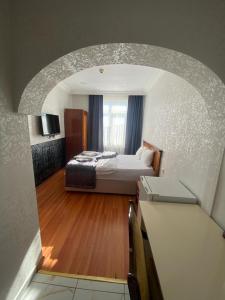 a hotel room with a bed and a window at Timeks Suite Sultanahmet in Istanbul