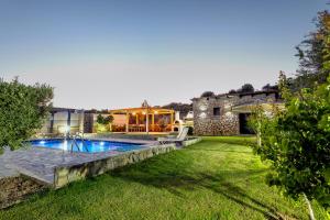 podwórko z basenem i domem w obiekcie Memi Beach front Villa w mieście Kiotari