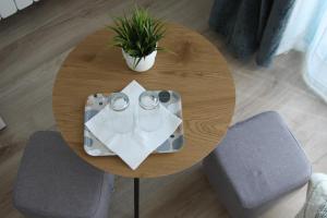 a round wooden table with a plant on top of it at Pensiunea Ataman in Murighiol