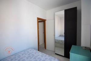 a bedroom with a mirror and a bed in it at Apartment with terrace in Malaga Center - TCM in Málaga