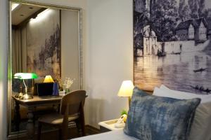 a bedroom with a bed and a desk with a laptop at Pierre Loti Hotel Old City- Special Category in Istanbul