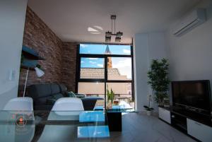 a living room with a couch and a glass table at Apartment with terrace in Malaga Center - TCM in Málaga