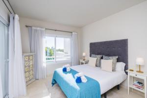 a bedroom with a large bed and a window at Al-411 Estepona - Apartment - Alcazaba Lagoon in Estepona +33 photos