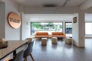 a waiting room with couches and tables in a building at RedDoorz near Mangga Dua Mall in Jakarta