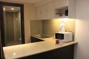a kitchen with a microwave sitting on a counter at Adha Studio & Suite Kota Bharu in Kota Bharu