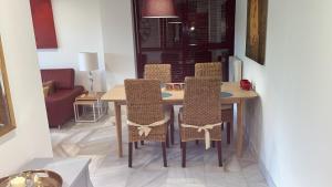 a dining room table and chairs in a room at Parque Botanico Resort in Estepona