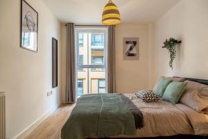 a bedroom with a bed and a large window at ✪ Natural Light City Center Pad ✪ Free Parking and Sleep 4 in Birmingham