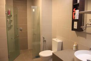 a bathroom with a shower with a toilet and a sink at Adha Studio & Suite Kota Bharu in Kota Bharu