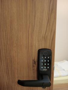 a remote control sticking out of a door at Villa Krasnowolska Airport - Self Check-in in Warsaw