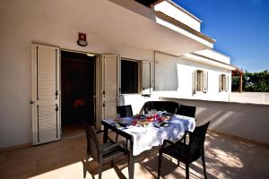 a table with chairs and food on a patio at Felicity Vieste in Vieste