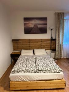 a bed in a bedroom with a wooden headboard at Apartment4 you in Vienna