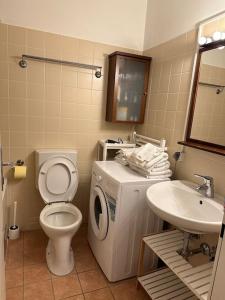 a bathroom with a toilet and a sink at Apartment4 you in Vienna