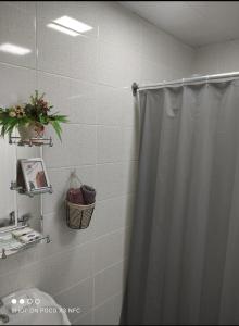 a bathroom with a shower curtain and a sink at CiciHome in Qusar