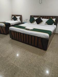two twin beds in a room with at hotel city, Star Hotels & Resorts, Amritsar in Amritsar