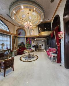 a large living room with a ceiling with a chandelier at Q Hotel in Beirut