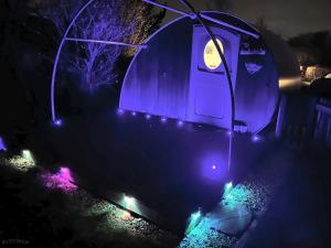 a blue tent with lights on a yard at night at Cosy 1 bedroom cabin- Moon Pod in Salisbury