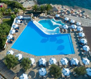 an overhead view of a swimming pool at a resort at Aquila Elounda Village Resort, Suites & Spa in Elounda