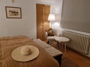 a room with a bed with a hat on it at Bed vue sur vallée de la Meuse Namur in Bouge