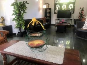 a living room with a table with a pumpkin on it at Kingz and Queenz - Negombo in Negombo