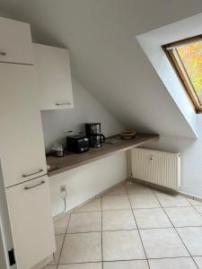 a small kitchen with a counter in the attic at Aminas Ferienwohnung Bad Gandersheim 30/2 in Bad Gandersheim