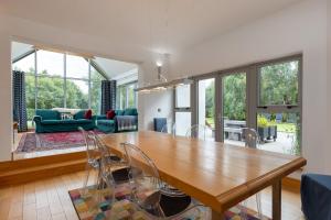 a dining room and living room with a table and chairs at Wildings Ardcavan in Wexford