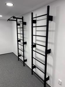 two black shelves in a room with a wall at Benecko - apartmán s výhledem in Benecko