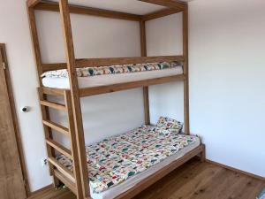 a bedroom with two bunk beds in a room at Benecko - apartmán s výhledem in Benecko