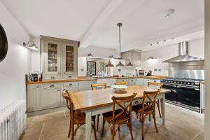 a kitchen with a wooden table and chairs at Old Hall Middle - Mayfield in Ashbourne