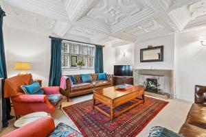 a living room with couches and a table and a fireplace at Old Hall Middle - Mayfield in Ashbourne