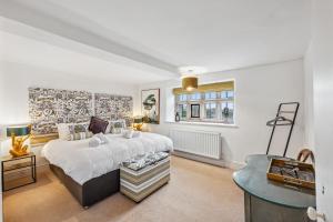 a bedroom with a large bed and a table at Old Hall Middle - Mayfield in Ashbourne