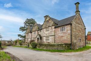 an old stone building with a pathway in front at Old Hall Middle - Mayfield in Ashbourne