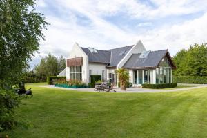 a house with a large lawn in front of it at Wildings Ardcavan in Wexford