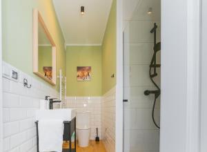 a bathroom with a sink and a shower at Apartamenty Piastowska in Nysa