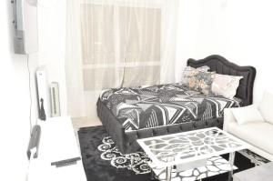 a living room with a bed and a coffee table at Cheap Professional Beautiful Studio Apartment in Bobigny