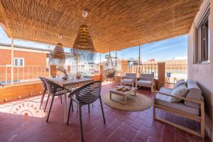 a patio with a table and chairs on a balcony at House in fishing village El Palo - TCM in Málaga