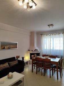 a living room with a table and a couch at Vasiliki house 1 in Vartholomio