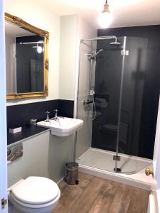 a bathroom with a shower and a toilet and a sink at The Wheatsheaf at Beetham in Sandside +31 photos