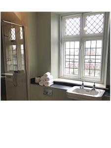 a bathroom with a sink and a shower with windows at The Wheatsheaf at Beetham in Sandside