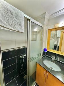a bathroom with a sink and a shower at Grand Papirus Hotel in Istanbul