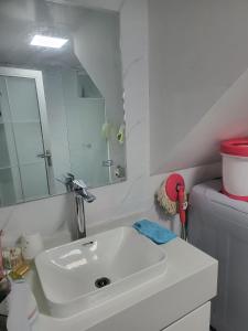 a bathroom with a white sink and a mirror at Morgan enmaison in Phnom Penh