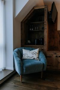 a blue couch in a living room with a television at The Ferry House in Eastchurch