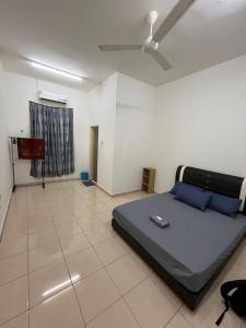 a bedroom with a bed and a ceiling fan at Zara Homestay in Marang