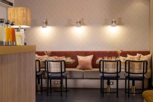 a dining room with a couch and a table and chairs at Le Bailli in Paris