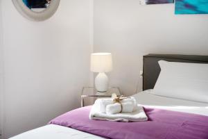 a hotel room with a bed with towels on it at Appartamento Al Corso in Salerno