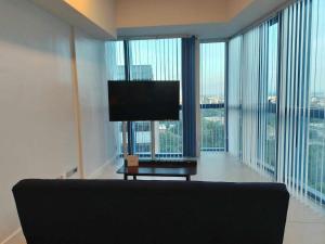 a living room with a couch and large windows at 38 Park Avenue condominium, IT Park in Cebu City